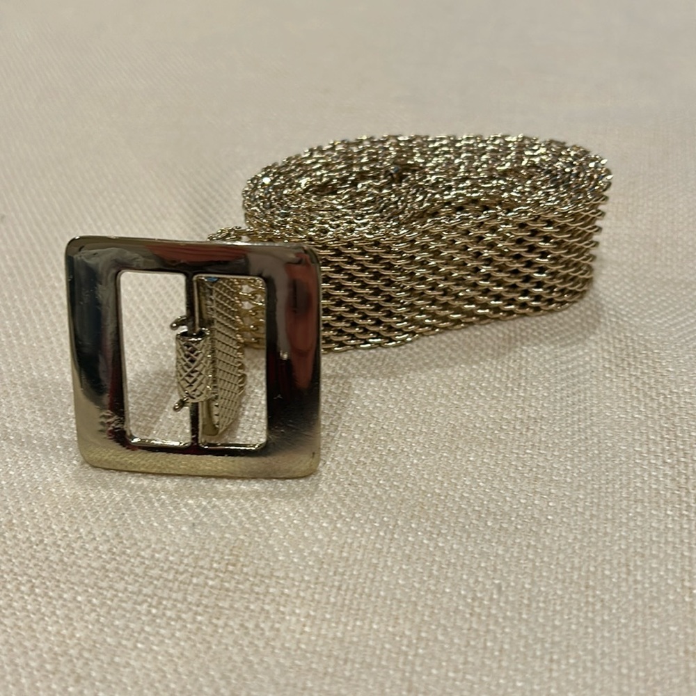 Cache gold colored mesh belt. Can be adjusted to waist size. Up to 40” & 1” wide
